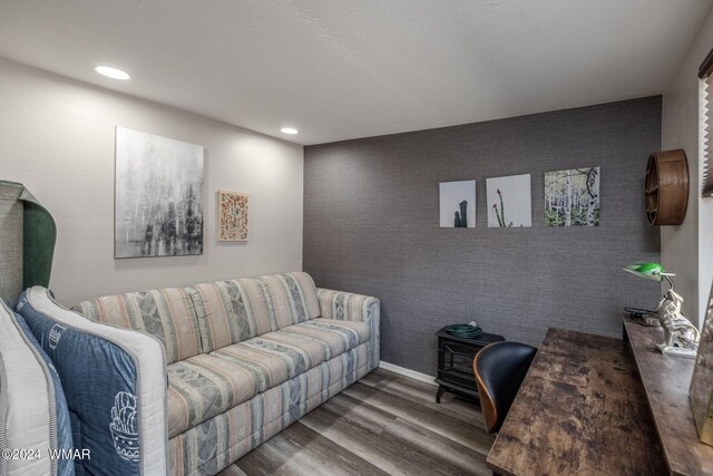 living room with baseboards, wallpapered walls, wood finished floors, and recessed lighting