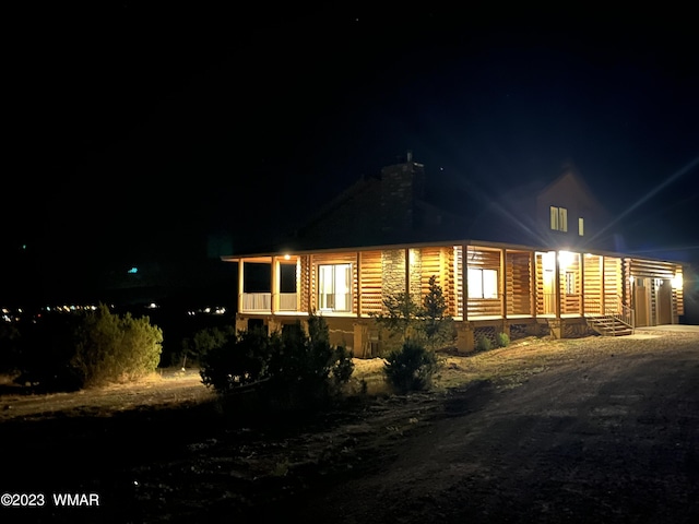 back of house at night with crawl space