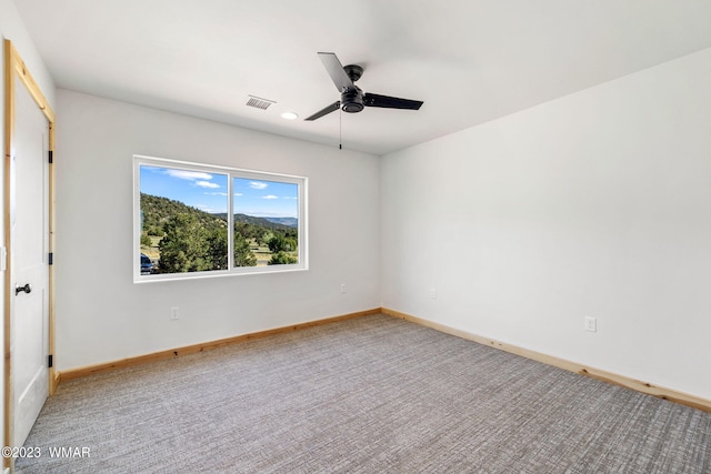 unfurnished bedroom featuring carpet flooring, visible vents, ceiling fan, and baseboards