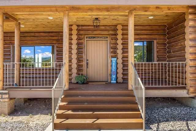 view of exterior entry with log exterior