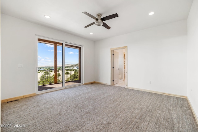 spare room featuring ceiling fan, recessed lighting, light carpet, visible vents, and baseboards