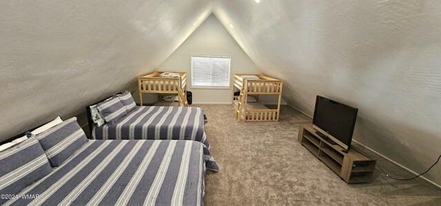 carpeted bedroom with lofted ceiling and a textured ceiling