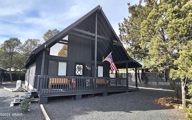 view of front of property with fence and a deck