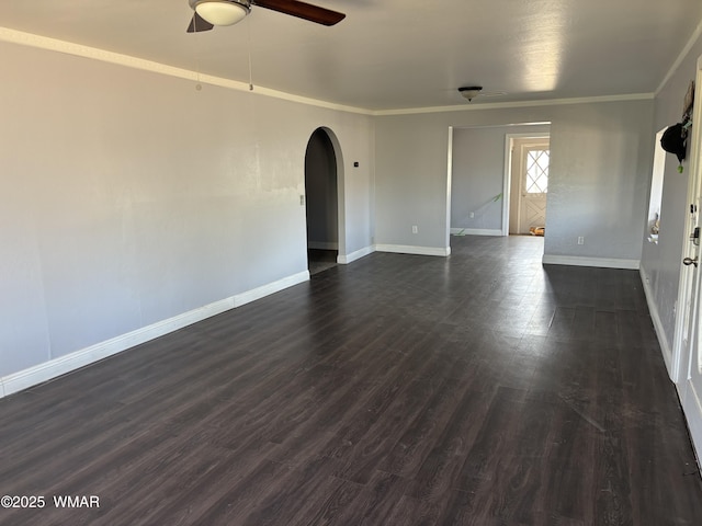 201 E Mcneil, Show Low, AZ 85901 - unfurnished room with arched walkways, a ceiling fan, ornamental molding, and dark wood-style floors