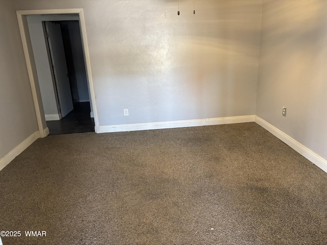 201 E Mcneil, Show Low, AZ 85901 - empty room with dark colored carpet and baseboards