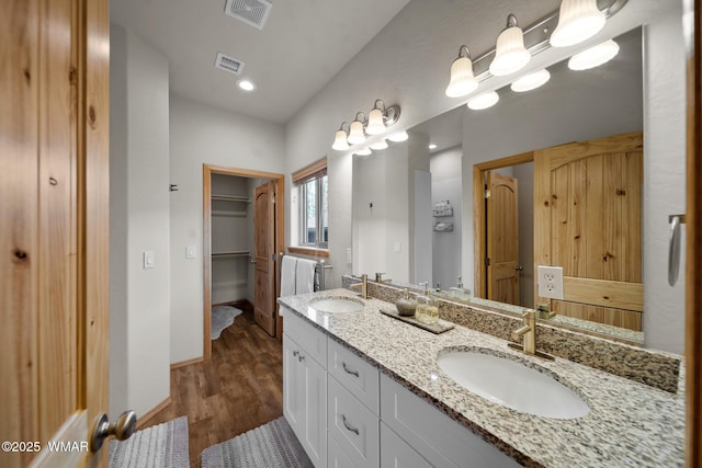 3050 W Black Oak Loop, Show Low, AZ 85901 - bathroom with wood finished floors, baseboards, double vanity, and a walk in closet