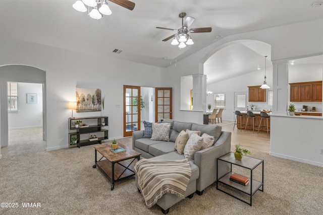 3401 W Hansen, Show Low, AZ 85901 - living area featuring vaulted ceiling, arched walkways, ceiling fan, light colored carpet, and plenty of natural light