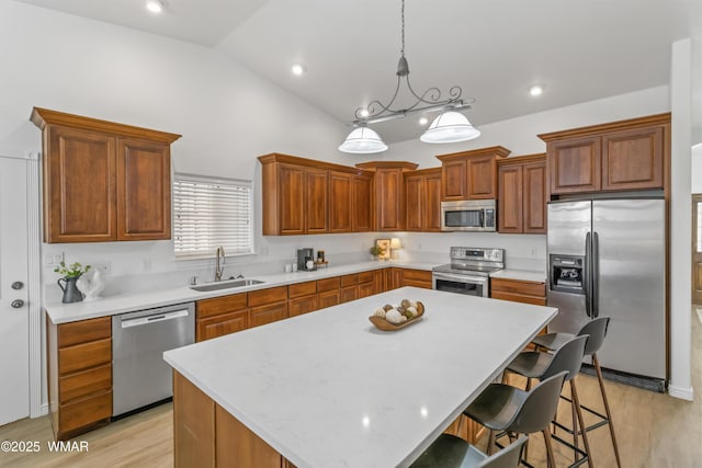 3401 W Hansen, Show Low, AZ 85901 - kitchen with appliances with stainless steel finishes, a sink, a center island, light countertops, and lofted ceiling