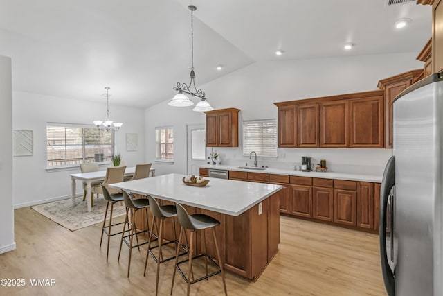 3401 W Hansen, Show Low, AZ 85901 - kitchen featuring stainless steel appliances, a sink, light wood-style flooring, vaulted ceiling, and light countertops