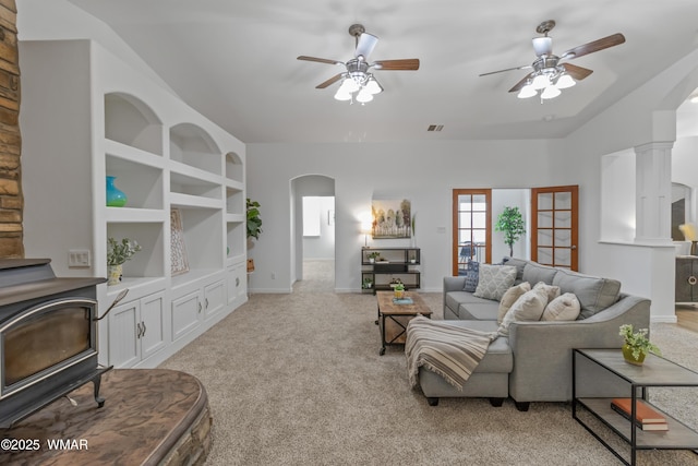 3401 W Hansen, Show Low, AZ 85901 - living area with arched walkways, a ceiling fan, a wood stove, light colored carpet, and lofted ceiling