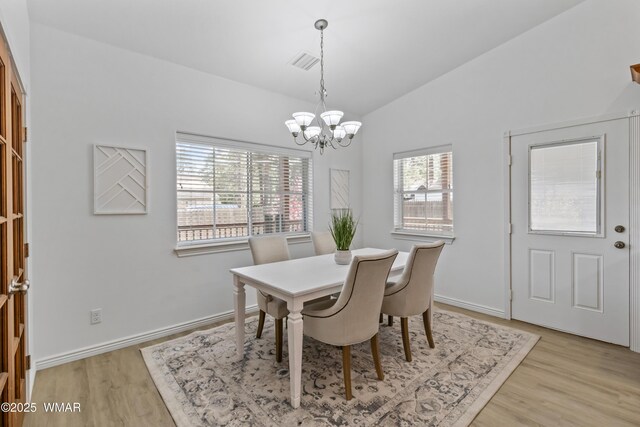 3401 W Hansen, Show Low, AZ 85901 - dining space with a chandelier, vaulted ceiling, light wood-style floors, and baseboards