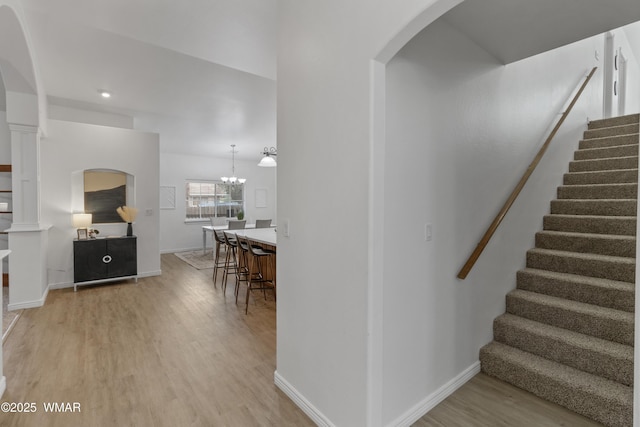 3401 W Hansen, Show Low, AZ 85901 - stairway featuring wood finished floors, arched walkways, a chandelier, and baseboards