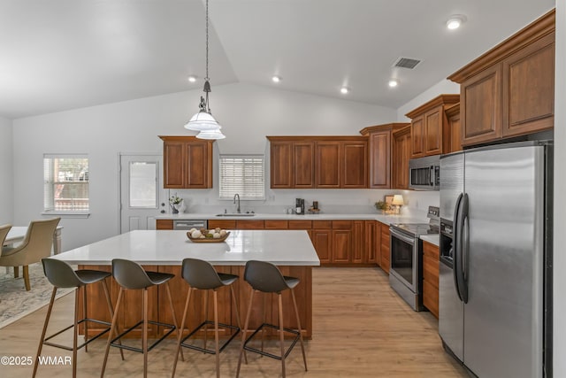 3401 W Hansen, Show Low, AZ 85901 - kitchen featuring appliances with stainless steel finishes, a sink, light countertops, a kitchen island, and light wood-type flooring