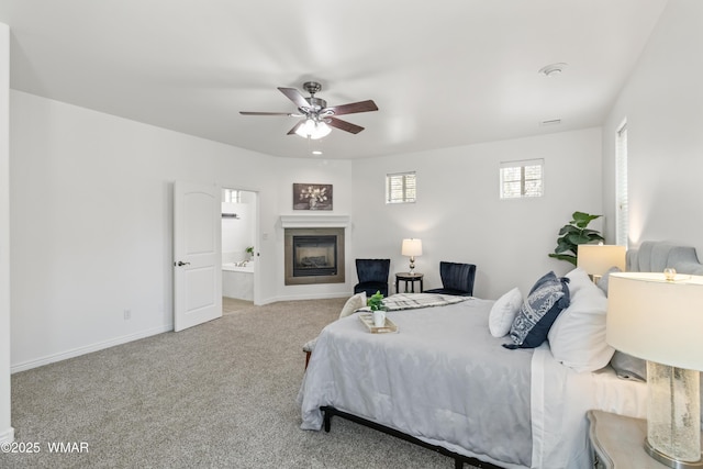 3401 W Hansen, Show Low, AZ 85901 - bedroom featuring carpet flooring, baseboards, a glass covered fireplace, a ceiling fan, and ensuite bath