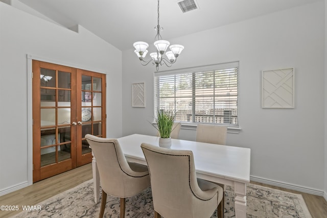 3401 W Hansen, Show Low, AZ 85901 - dining space with french doors, light wood-style flooring, a chandelier, lofted ceiling, and baseboards