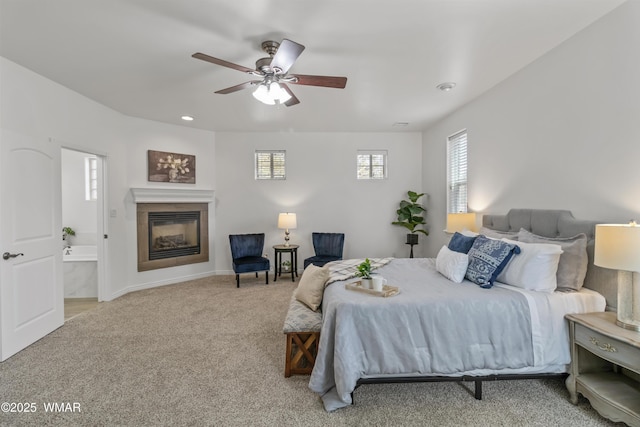 3401 W Hansen, Show Low, AZ 85901 - carpeted bedroom featuring a glass covered fireplace, baseboards, a ceiling fan, recessed lighting, and ensuite bath