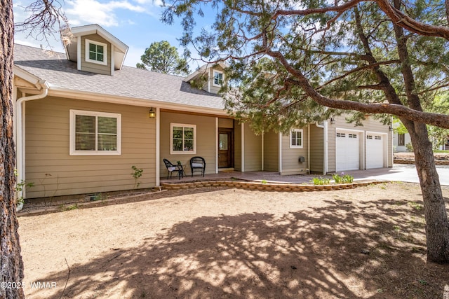 3401 W Hansen, Show Low, AZ 85901 - view of front of home with a porch, concrete driveway, a shingled roof, and an attached garage