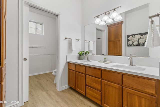 3401 W Hansen, Show Low, AZ 85901 - bathroom featuring wood finished floors, double vanity, toilet, and a chandelier
