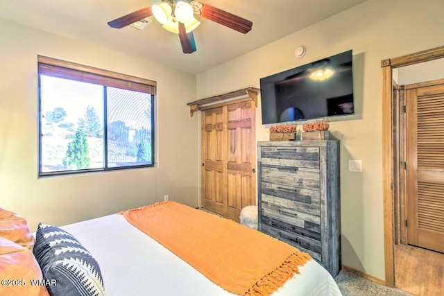 bedroom with carpet flooring, baseboards, and a ceiling fan