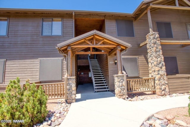 view of front of house with covered porch and stairs