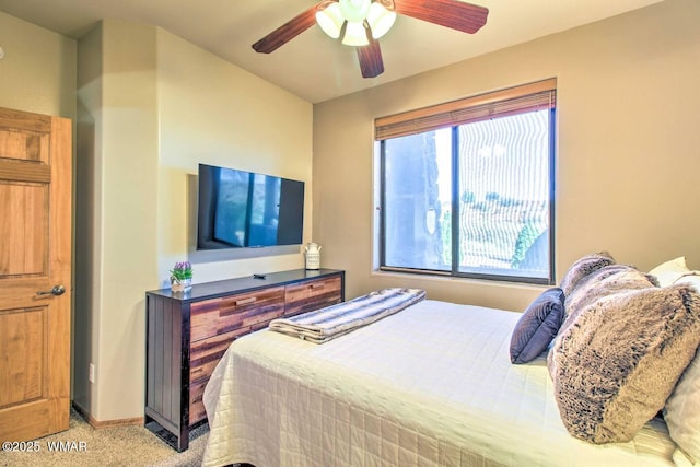 bedroom with light colored carpet, baseboards, and ceiling fan