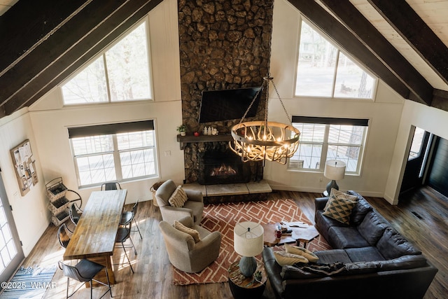 4273 Branding Iron Loop, Pinetop, AZ 85935 - living area with plenty of natural light, hardwood / wood-style floors, beam ceiling, high vaulted ceiling, and a stone fireplace