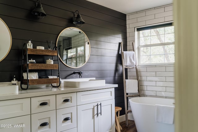 4273 Branding Iron Loop, Pinetop, AZ 85935 - full bath with wood walls, a freestanding tub, double vanity, and wood finished floors