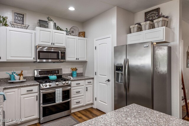 274 Mountain View Dr, Lakeside, AZ 85929 - kitchen with stainless steel appliances, white cabinetry, dark wood-style floors, recessed lighting, and light stone countertops