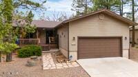 view of front facade featuring a porch, concrete driveway, and a garage