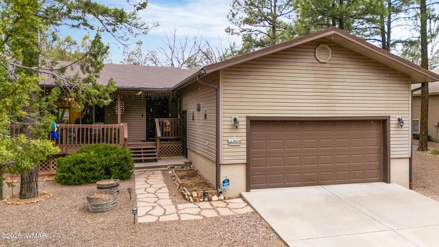 single story home with a deck, driveway, a shingled roof, and a garage