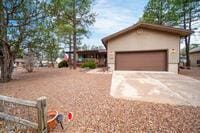 view of yard featuring concrete driveway and an attached garage