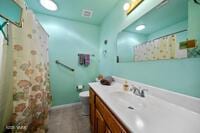 bathroom featuring vanity, toilet, and a shower with curtain