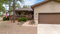 view of front of property featuring concrete driveway and an attached garage