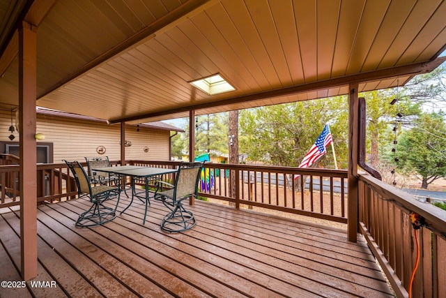 wooden deck featuring outdoor dining space