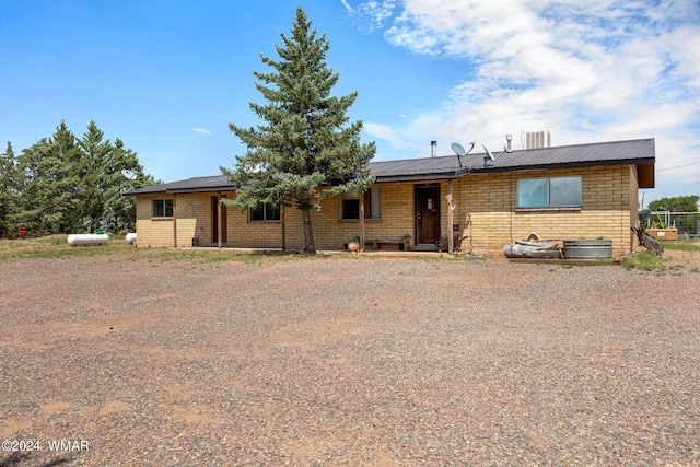 ranch-style home featuring metal roof