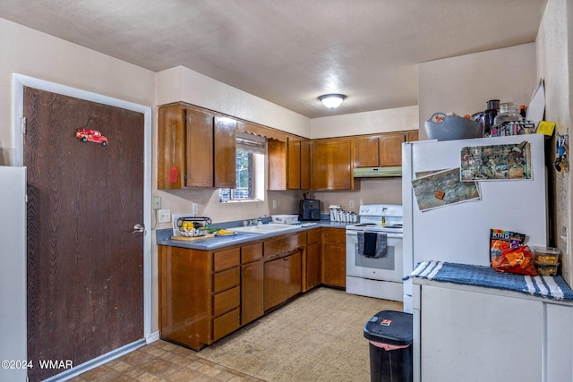 kitchen featuring white electric stove, brown cabinets, under cabinet range hood, light floors, and a sink