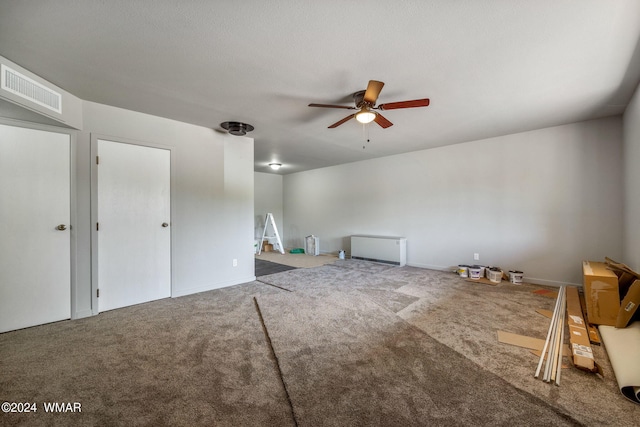 additional living space featuring carpet, visible vents, and a ceiling fan