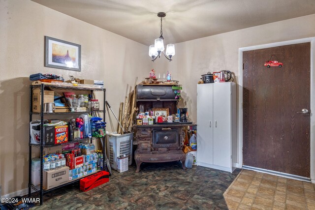 dining area with stone finish flooring, a notable chandelier, and baseboards