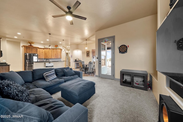 living room featuring light carpet, a ceiling fan, and recessed lighting