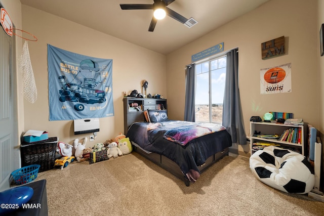 carpeted bedroom featuring a ceiling fan and visible vents