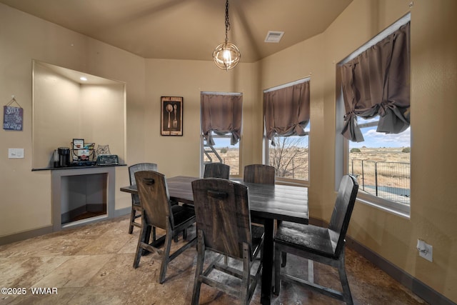 dining space featuring baseboards and visible vents