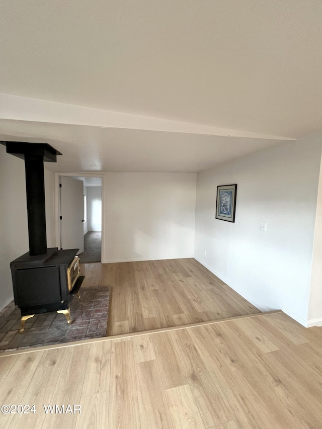 living area featuring a wood stove and wood finished floors