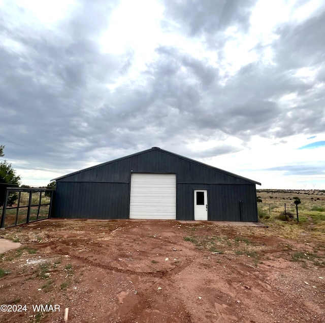 view of outdoor structure featuring an outbuilding and fence