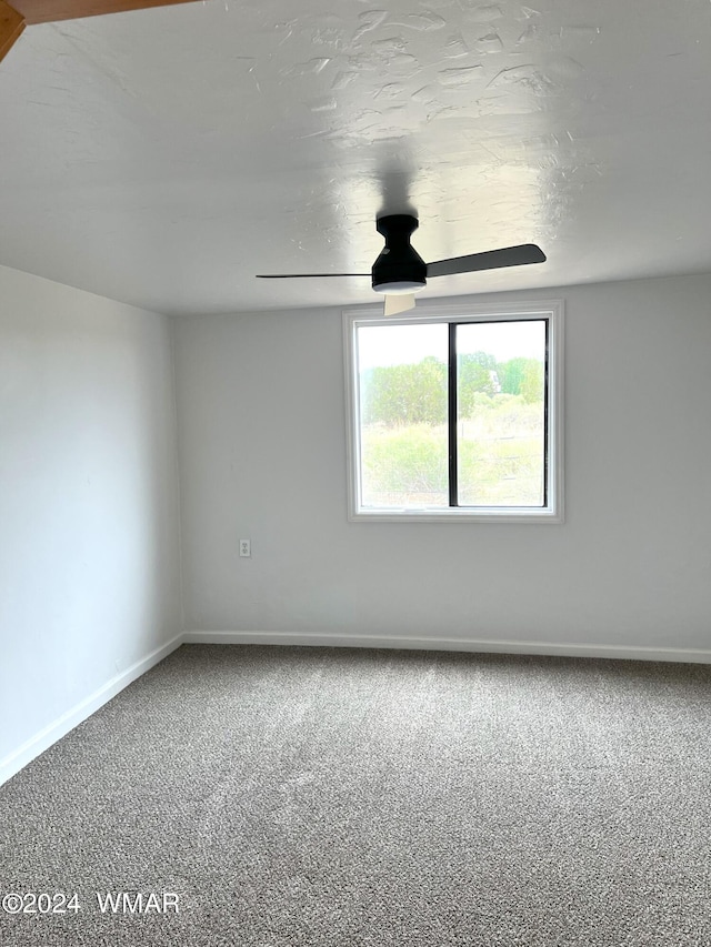 unfurnished room featuring ceiling fan, baseboards, and carpet flooring