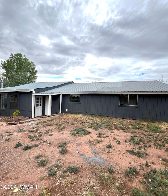 rear view of house with metal roof