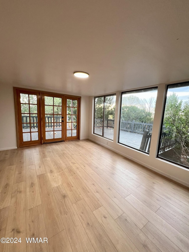 empty room with light wood-style flooring and baseboards