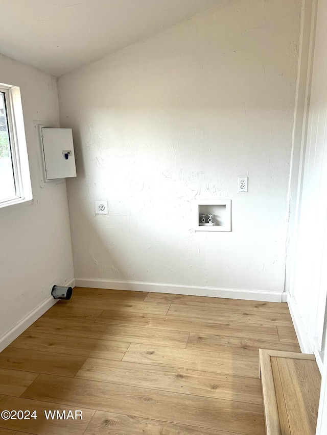 clothes washing area with laundry area, baseboards, light wood-style floors, washer hookup, and electric dryer hookup