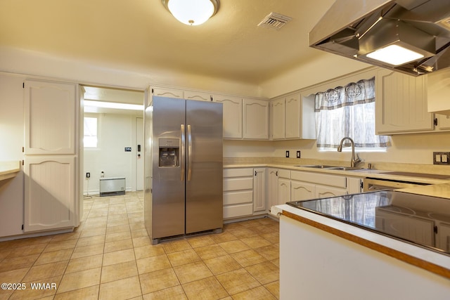15 N 1st E St, Snowflake, AZ 85937 - kitchen featuring stainless steel fridge, ventilation hood, light countertops, and white cabinetry