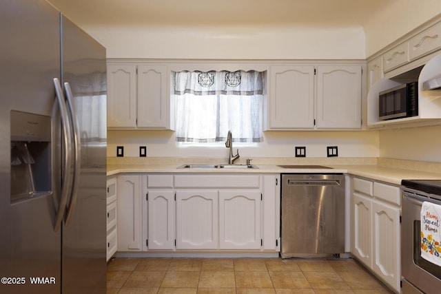 15 N 1st E St, Snowflake, AZ 85937 - kitchen with stainless steel appliances, light countertops, light tile patterned flooring, and white cabinetry