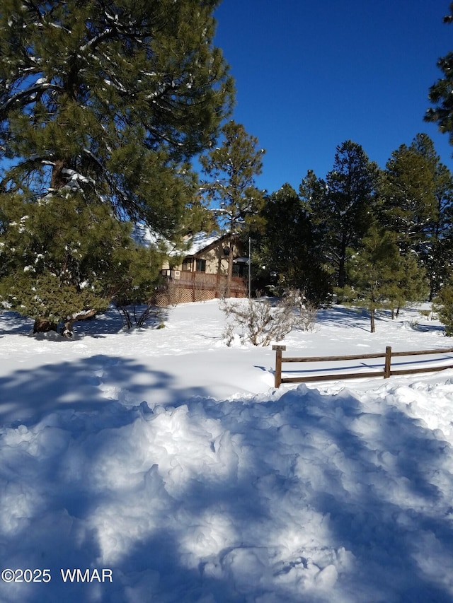 yard layered in snow with fence